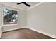 This well lit bedroom has hardwood floors and a large window showcasing the outdoors at 712 W Plymouth St, Tampa, FL 33603