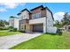 Contemporary two-story home with a modern design, landscaped yard, and a sleek driveway at 712 W Plymouth St, Tampa, FL 33603