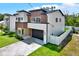 Modern two-story house with a well-manicured lawn and sleek driveway at 712 W Plymouth St, Tampa, FL 33603