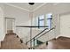 A hallway is showcased with hardwood floors, a glass railing, and a modern light fixture at 712 W Plymouth St, Tampa, FL 33603