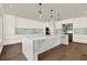 A modern, spacious kitchen with white cabinets, marble countertops and backsplash, and stainless steel appliances at 712 W Plymouth St, Tampa, FL 33603
