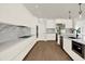 Bright kitchen with stainless steel appliances, marble backsplash, island and modern white cabinets at 712 W Plymouth St, Tampa, FL 33603