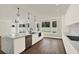 Kitchen area featuring a large island with seating, stainless steel appliances, and modern white cabinets at 712 W Plymouth St, Tampa, FL 33603