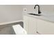 Bright laundry room features stylish cabinets, a sleek black faucet, and a marble countertop at 712 W Plymouth St, Tampa, FL 33603