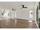 Bright living room with hardwood floors, large windows providing ample natural light, and a modern ceiling fan at 712 W Plymouth St, Tampa, FL 33603