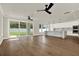 Spacious open-concept living area and kitchen with hardwood floors and large windows, great flow at 712 W Plymouth St, Tampa, FL 33603