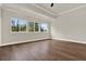 Light-filled main bedroom with hardwood floors and trey ceiling at 712 W Plymouth St, Tampa, FL 33603