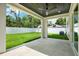 Covered patio with ceiling fan and a view of the spacious, well-manicured backyard at 712 W Plymouth St, Tampa, FL 33603