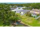An aerial view of property with scenic backyard pond and lush landscaping at 7157 Hamilton Park Blvd, Tampa, FL 33615