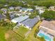 An aerial view displays backyard, nearby houses and fence, surrounded by lush greenery at 7157 Hamilton Park Blvd, Tampa, FL 33615
