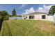 Well-maintained backyard with lush green grass, white fencing, and a charming playset at 7157 Hamilton Park Blvd, Tampa, FL 33615