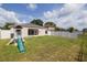 Well-maintained backyard with a playset and screened-in patio at 7157 Hamilton Park Blvd, Tampa, FL 33615