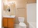 Cozy bathroom with large mirror, white tile, standard toilet, and vanity at 7157 Hamilton Park Blvd, Tampa, FL 33615