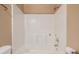 The neutral bathroom showcases a tub and shower with built in shelving at 7157 Hamilton Park Blvd, Tampa, FL 33615