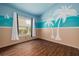 Bright bedroom features nautical theme and wood-look flooring, creating a playful, beachy vibe at 7157 Hamilton Park Blvd, Tampa, FL 33615