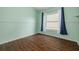 A bright bedroom with a large window and wood-look flooring, ideal for relaxation at 7157 Hamilton Park Blvd, Tampa, FL 33615