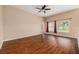 Cozy bedroom boasts wood floors, a ceiling fan, and a serene view from its large windows at 7157 Hamilton Park Blvd, Tampa, FL 33615