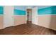 Bedroom features rich flooring, themed walls, and an open doorway to another part of the home at 7157 Hamilton Park Blvd, Tampa, FL 33615