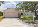 Single-story home boasts a well-manicured lawn, two-car garage, and a neatly maintained landscape at 7157 Hamilton Park Blvd, Tampa, FL 33615