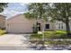 Inviting one-story home with a lush lawn, convenient two-car garage, and charming curb appeal at 7157 Hamilton Park Blvd, Tampa, FL 33615