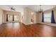 Spacious living area with wood flooring, ample natural light, and seamless flow into the kitchen at 7157 Hamilton Park Blvd, Tampa, FL 33615