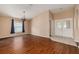 Bright open-plan living area with hardwood floors, a chandelier and easy access to the foyer at 7157 Hamilton Park Blvd, Tampa, FL 33615