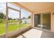 Screened-in patio looking out to a spacious backyard with a playground at 7157 Hamilton Park Blvd, Tampa, FL 33615