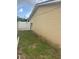 A grassy backyard is adjacent to the home's exterior at 7206 Reindeer Rd, Tampa, FL 33619