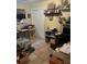 View of a cluttered bedroom with tiled flooring and packed with personal items at 7206 Reindeer Rd, Tampa, FL 33619