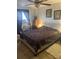 Cozy bedroom featuring a large bed, tiled flooring, and decorative wall art at 7206 Reindeer Rd, Tampa, FL 33619
