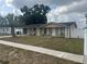 Single-story home with a covered porch, columns, and a well-maintained front yard at 7206 Reindeer Rd, Tampa, FL 33619