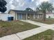 Charming single-story home with front yard, walkway, and mature palm tree at 7206 Reindeer Rd, Tampa, FL 33619