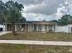 A one-story home with a palm tree and white picket fence at 7206 Reindeer Rd, Tampa, FL 33619