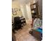A home office featuring tile flooring, bookshelves, and office equipment at 7206 Reindeer Rd, Tampa, FL 33619