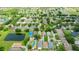 This is an aerial view of homes with a pond and tree-lined streets in a residential neighborhood at 9852 Laurel Ledge Dr, Riverview, FL 33569