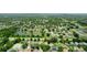 Aerial view of a residential neighborhood with a pond and lush green trees surrounding the houses at 9852 Laurel Ledge Dr, Riverview, FL 33569