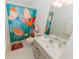 Bright bathroom with a white vanity and colorful floral shower curtain at 9852 Laurel Ledge Dr, Riverview, FL 33569