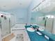 Bright bathroom features double vanity, separate shower and soaking tub and a blue and white decor at 9852 Laurel Ledge Dr, Riverview, FL 33569
