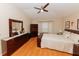 Spacious bedroom with a dark wood dresser, mirror, and bay windows at 9852 Laurel Ledge Dr, Riverview, FL 33569