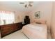 Serene bedroom with a soft pink color scheme and comfortable furnishings at 9852 Laurel Ledge Dr, Riverview, FL 33569