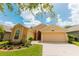Charming single-story home featuring a 2-car garage and well-manicured landscaping on a sunny day at 9852 Laurel Ledge Dr, Riverview, FL 33569