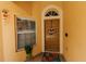 Inviting front entryway with a decorative wreath, tiled floor, and vibrant flower pot at 9852 Laurel Ledge Dr, Riverview, FL 33569