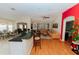 Bright open-concept living area with hardwood floors, connecting kitchen, dining nook, and living room at 9852 Laurel Ledge Dr, Riverview, FL 33569