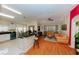 Bright open-concept living area with hardwood floors, connecting kitchen, dining nook, and living room at 9852 Laurel Ledge Dr, Riverview, FL 33569