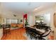 Open-concept living room, dining room and kitchen with hardwood floors and abundant natural light at 9852 Laurel Ledge Dr, Riverview, FL 33569