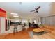 Open concept living space with stainless steel appliances, bar seating, and a comfortable leather couch at 9852 Laurel Ledge Dr, Riverview, FL 33569