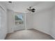 Bright bedroom features a ceiling fan, carpet flooring, and a large window at 1004 Black Knight Dr, Valrico, FL 33594