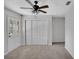 Clean, neutral bedroom with a ceiling fan, closet, and an exterior door for easy access at 1004 Black Knight Dr, Valrico, FL 33594