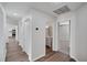 This home hallway has hardwood floors, closet storage, and access to bedrooms and bathrooms at 1004 Black Knight Dr, Valrico, FL 33594