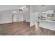 Bright and spacious living room featuring vaulted ceilings and hardwood floors with an adjacent open-concept kitchen at 1004 Black Knight Dr, Valrico, FL 33594